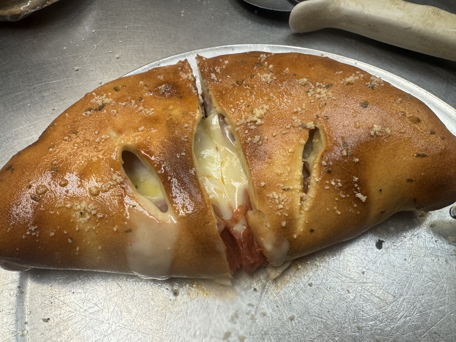 A freshly baked stromboli sliced and ready to serve